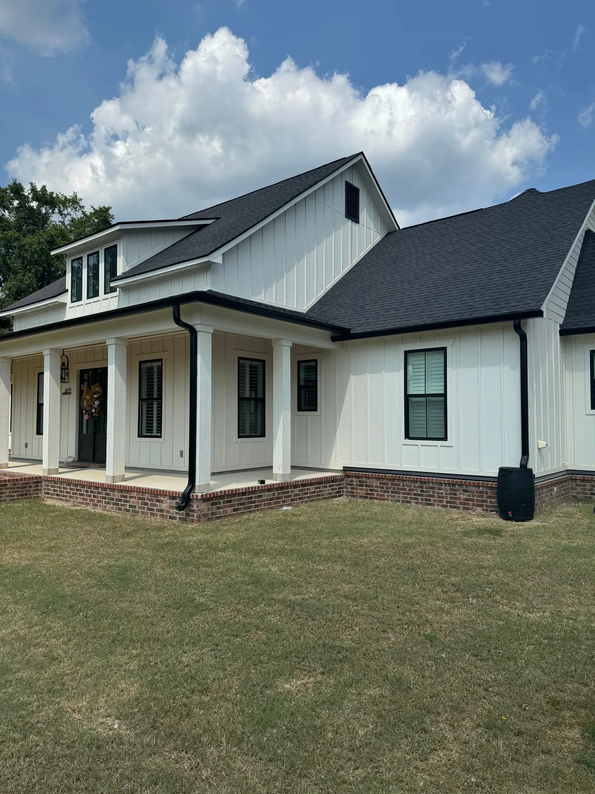 White home with gabled rooflines and dark gutters